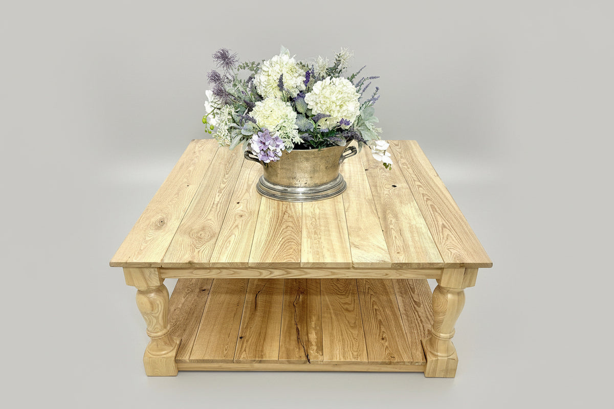 Handcrafted rustic farmhouse coffee table with thick reclaimed wood legs. Natural saw marks and knots add vintage charm